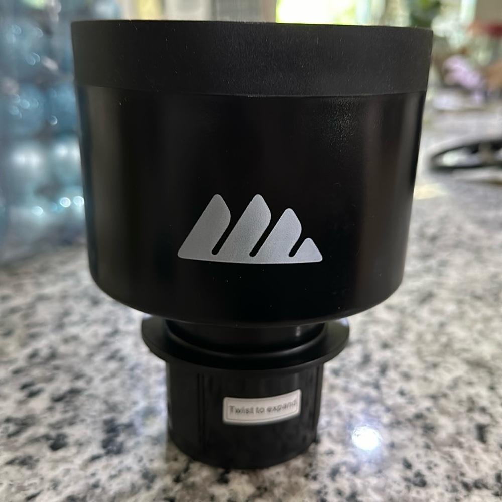 New integral cup holder extension for vehicles.